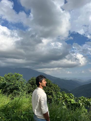 a man standing on top of a hill with a view at Green and Green in Vagamon