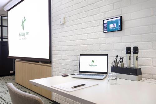a laptop computer sitting on a white desk at Holiday Inn Melbourne Bourke Street Mall by IHG in Melbourne