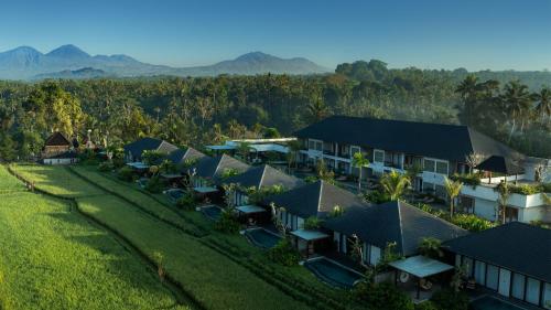 an aerial view of a resort with mountains in the background at Inara Alas Harum in Ubud