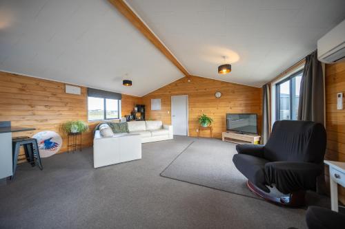 a living room with a couch and a television at Anderson Escape in Te Anau