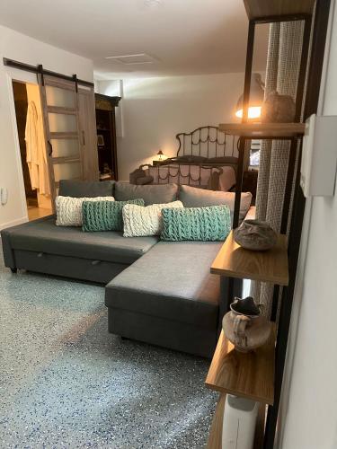 a living room with a couch and a bed at Flora's Garden Apartment/Studio in North Miami