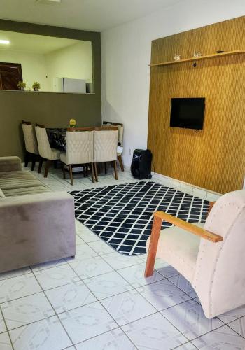 a living room with a couch and a table at Casa de Praia - Recanto dos Pássaros in Ilhéus