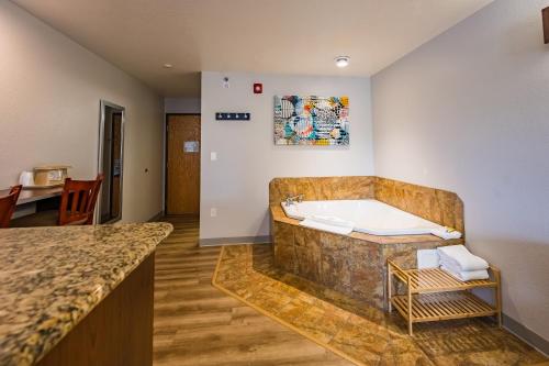 a large bathroom with a tub in a room at Microtel Inn & Suites Cheyenne in Cheyenne