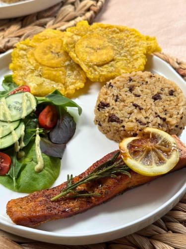 a plate of food with meat and vegetables on a table at Montes De Beraka in Minca