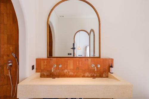 a bathroom with a wooden sink with a mirror at MarenaSol Villa Bingin, 1 BR Luxury Private Villa in Uluwatu