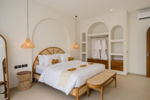 a white bedroom with a large bed and a mirror at MarenaSol Villa Bingin, 1 BR Luxury Private Villa in Uluwatu