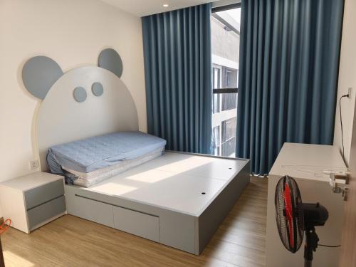 a bedroom with a bed with a mouse head on it at Luxhomes TC1 Canopy Smart City in Phú Thú