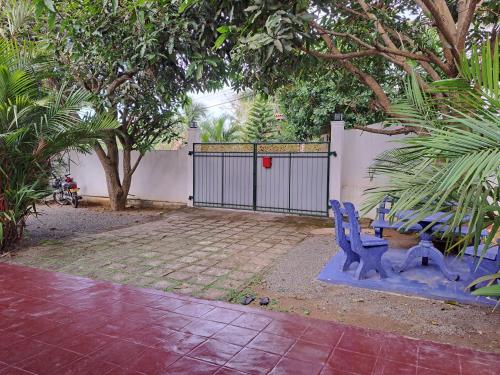 a blue bench sitting in front of a gate at Shady Homestay in Matara