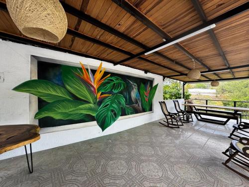 a painting of a patio with chairs and a table at Villa Cris Minca in Minca