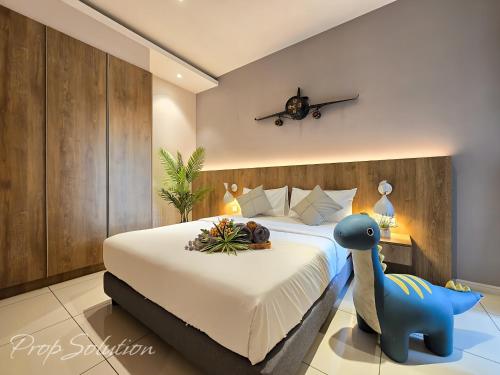 a bedroom with a bed with a blue dinosaur on it at Spacious Cozy Elysia Suite Johor Bahru Legoland in Iskandar Puteri