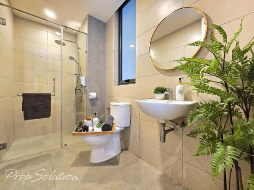 a bathroom with a toilet and a sink and a mirror at Spacious Cozy Elysia Suite Johor Bahru Legoland in Iskandar Puteri