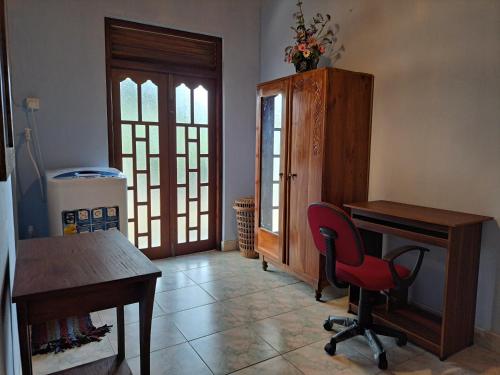 a room with a desk and a red chair at Shady Homestay in Matara