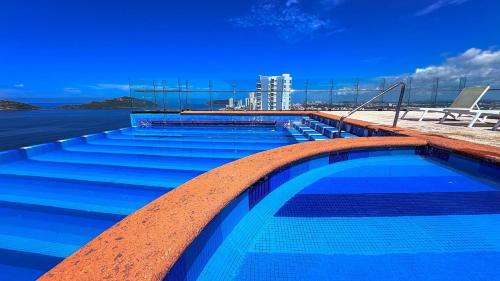 a swimming pool on the top of a building at Torre Central 102: Malecón, Lujo y Vistas de ensueño. in Mazatlán