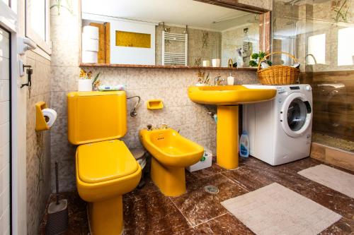 a bathroom with a yellow toilet and a sink at Ρετιρέ με θέα in Athens
