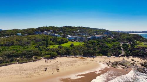 an aerial view of a beach with a group of people at Unit 2 Beach Gallery in Yaroomba