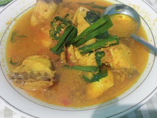 a bowl of soup with vegetables and a spoon at OMBAR Homestay in Minyaifuin