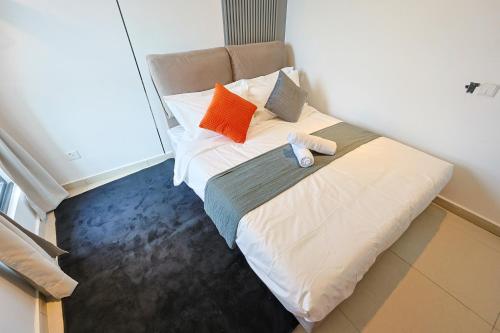 a bed with two pillows on it in a room at Paxtonz Exsim By NexxField in Petaling Jaya