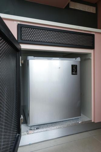 a large screen tv sitting in a room at Paxtonz Exsim By NexxField in Petaling Jaya