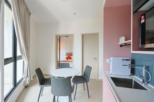 a kitchen with a table and chairs in a room at Paxtonz Exsim By NexxField in Petaling Jaya
