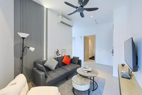 a living room with a couch and a ceiling fan at Paxtonz Exsim By NexxField in Petaling Jaya