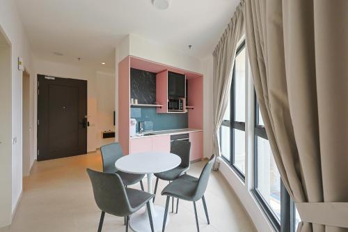 a kitchen and dining room with a table and chairs at Paxtonz Exsim By NexxField in Petaling Jaya
