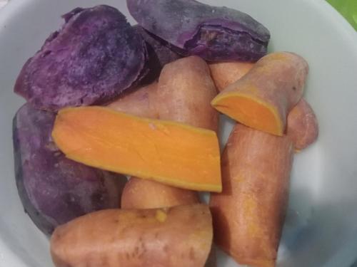a white bowl filled with carrots and other vegetables at OMBAR Homestay in Minyaifuin