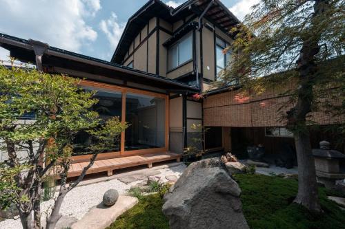 a house with a large window on the side of it at 飛騨高山一の響 in Wada