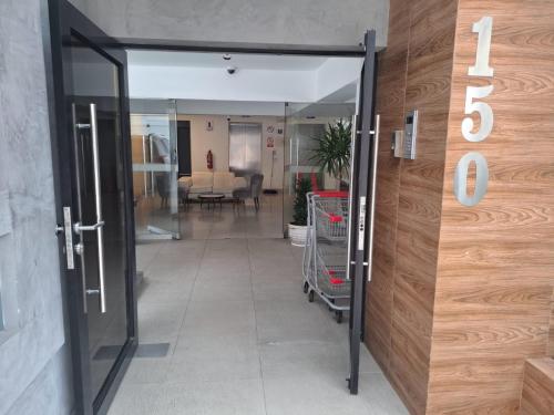 an open door to a hallway with a shopping cart at Bonito Departamento con estacionamiento, vista a parque y estadio nacional, muy tranquilo in Lima
