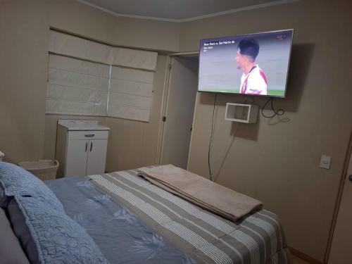a projection screen in a room with a bed at Bonito Departamento con estacionamiento, vista a parque y estadio nacional, muy tranquilo in Lima