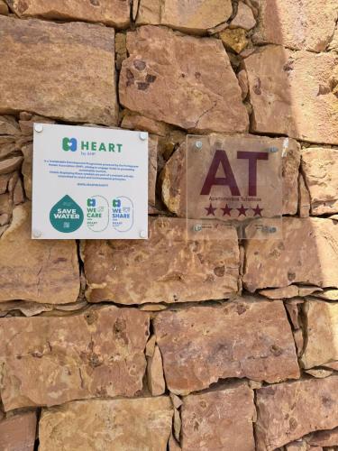 a stone wall with aat signs on it at FourSeasons Vilamoura in Quarteira