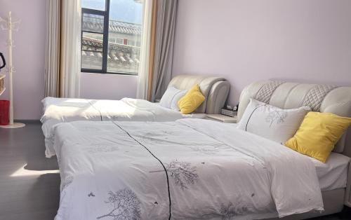 Postel nebo postele na pokoji v ubytování Dali Sifan Homestay