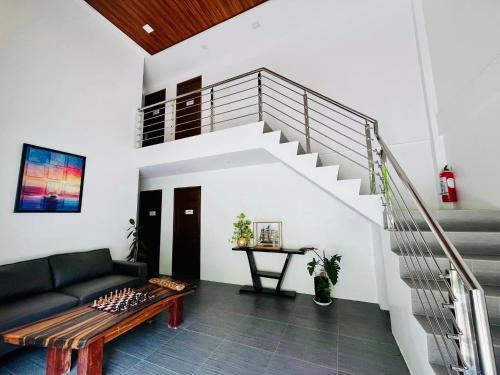 a living room with a couch and stairs at Porto Novo Anilao Dive and Leisure Resort in Mabini
