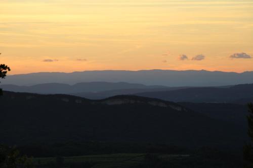 a view of the mountains at sunset at Pousterle de Sabran - Piscine & Hammam in Sabran