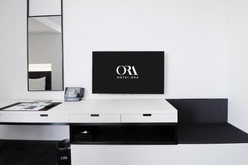 a white desk with a monitor on top of it at Hotel ORA Incheon in Incheon