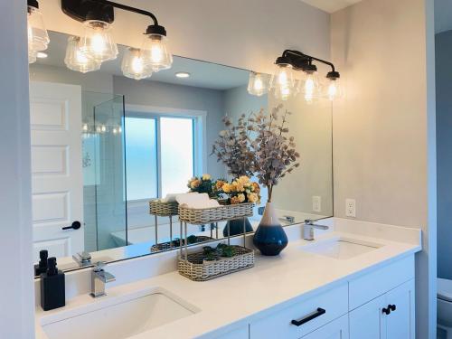 a bathroom with a sink and a mirror at The Downtown Oasis - A Spacious Family Friendly 3 Bedroom House Close to Everything in Edmonton