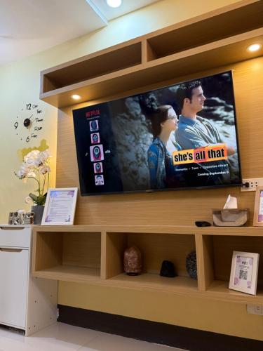 a flat screen tv sitting on top of a shelf at Elly's Place in Quezon City