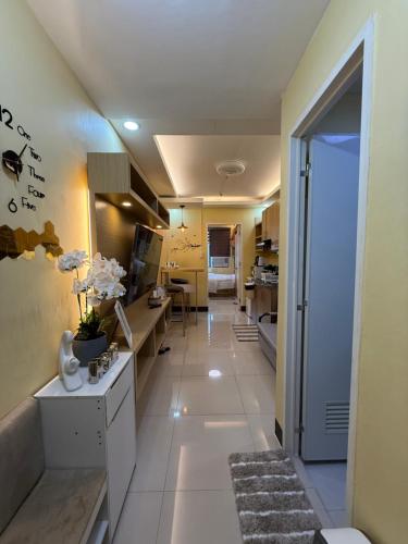 a hallway of a apartment with a kitchen and a living room at Elly's Place in Quezon City