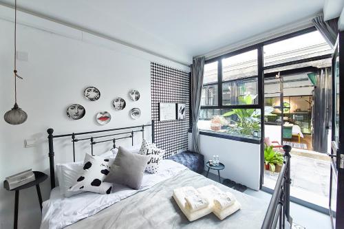 a bedroom with a bed and a large window at Goodnight hotel in the ancient Hutong in Beijing