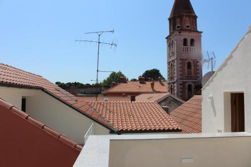 a view of a city with a clock tower and roofs at Idassa Atrium rooms in Zadar