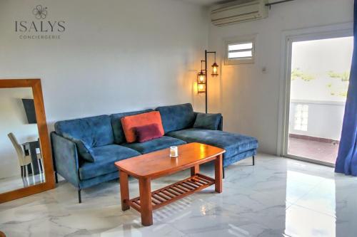 a living room with a blue couch and a coffee table at 1bd apartment with Gulf View Pointe Pirouette in Lowlands