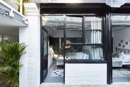 a glass door leading to a bedroom in a house at Goodnight hotel in the ancient Hutong in Beijing