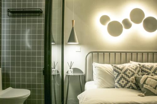 a bedroom with a bed and a shower with a toilet at Goodnight hotel in the ancient Hutong in Beijing