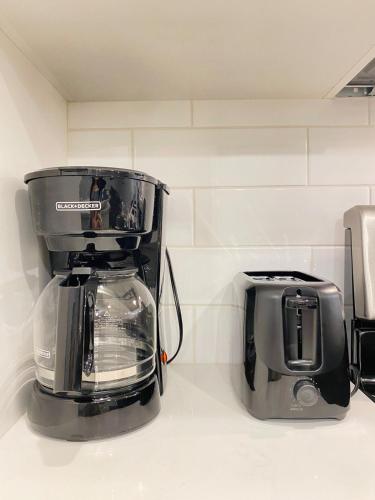 a blender sitting on a counter next to a toaster at The Private Central Edmonton Suite - Comfortable & Fully-Equipped Basement Suite in Edmonton