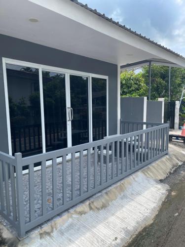 a house with a porch with sliding glass doors at S & K surin in Ban Khi Lek