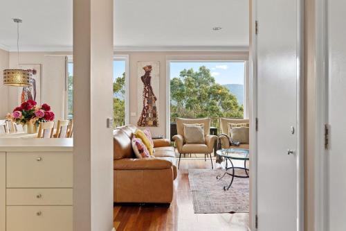 a living room with a couch and chairs at Golf & Wine Country Villa Cypress in Pokolbin
