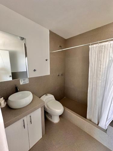 a bathroom with a toilet and a sink and a shower at Casa Bahía El Ñuro in El Ñuro