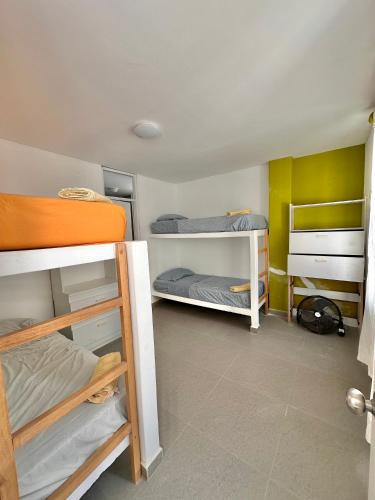a dorm room with three bunk beds in it at Casa Bahía El Ñuro in El Ñuro