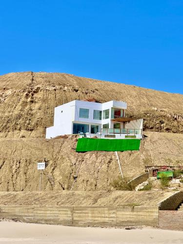 a house on the side of a hill at Casa Bahía El Ñuro in El Ñuro