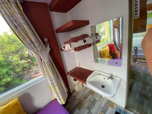 a small bathroom with a sink and a window at OYO 94764 Syariah KamarGue in Jakarta