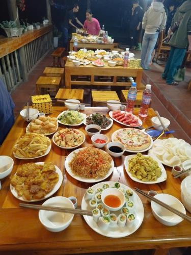 a table with many plates of food on it at Homestay Tommy House in Ha Giang